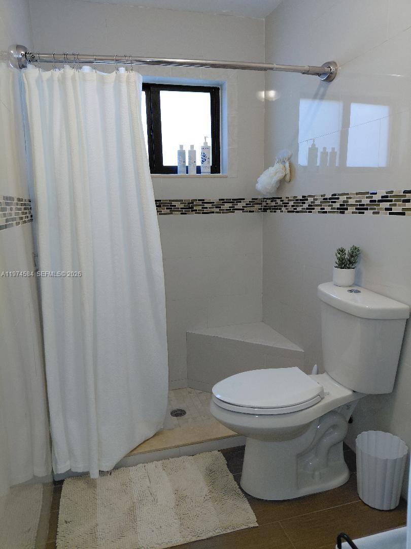 15630 Southwest 146th Avenue Miami, FL 33177 - Photo 18 of 23 a white toilet sitting next to a bathroom sink