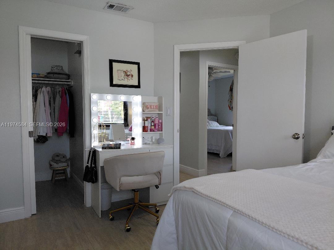 15630 Southwest 146th Avenue Miami, FL 33177 - Photo 20 of 23 a bedroom with a bed and a table in it
