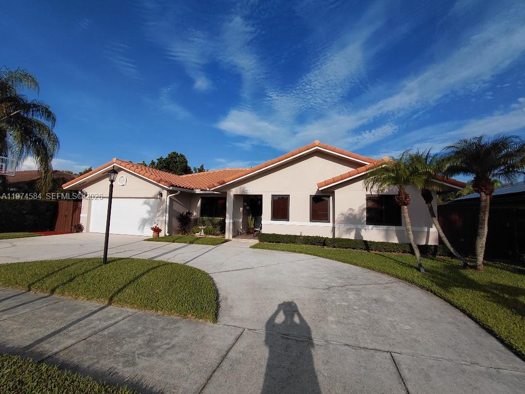 15630 Southwest 146th Avenue Miami, FL 33177 - Photo 2 of 23 a view of a house with backyard and trees