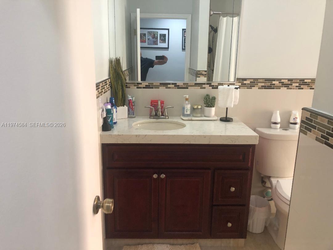 15630 Southwest 146th Avenue Miami, FL 33177 - Photo 22 of 23 a bathroom with a sink vanity and a mirror