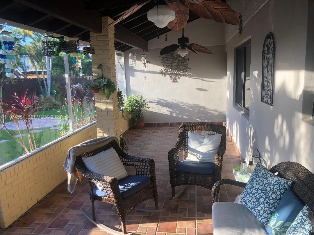 15630 Southwest 146th Avenue Miami, FL 33177 - Photo 9 of 23 a outdoor living space with furniture and a potted plant