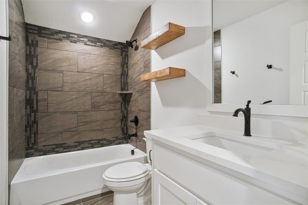 117 Sammy Street Godley, TX 76044 - Photo 24 of 27 a bathroom with a sink toilet and shower