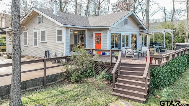 a view of a house with backyard and sitting area