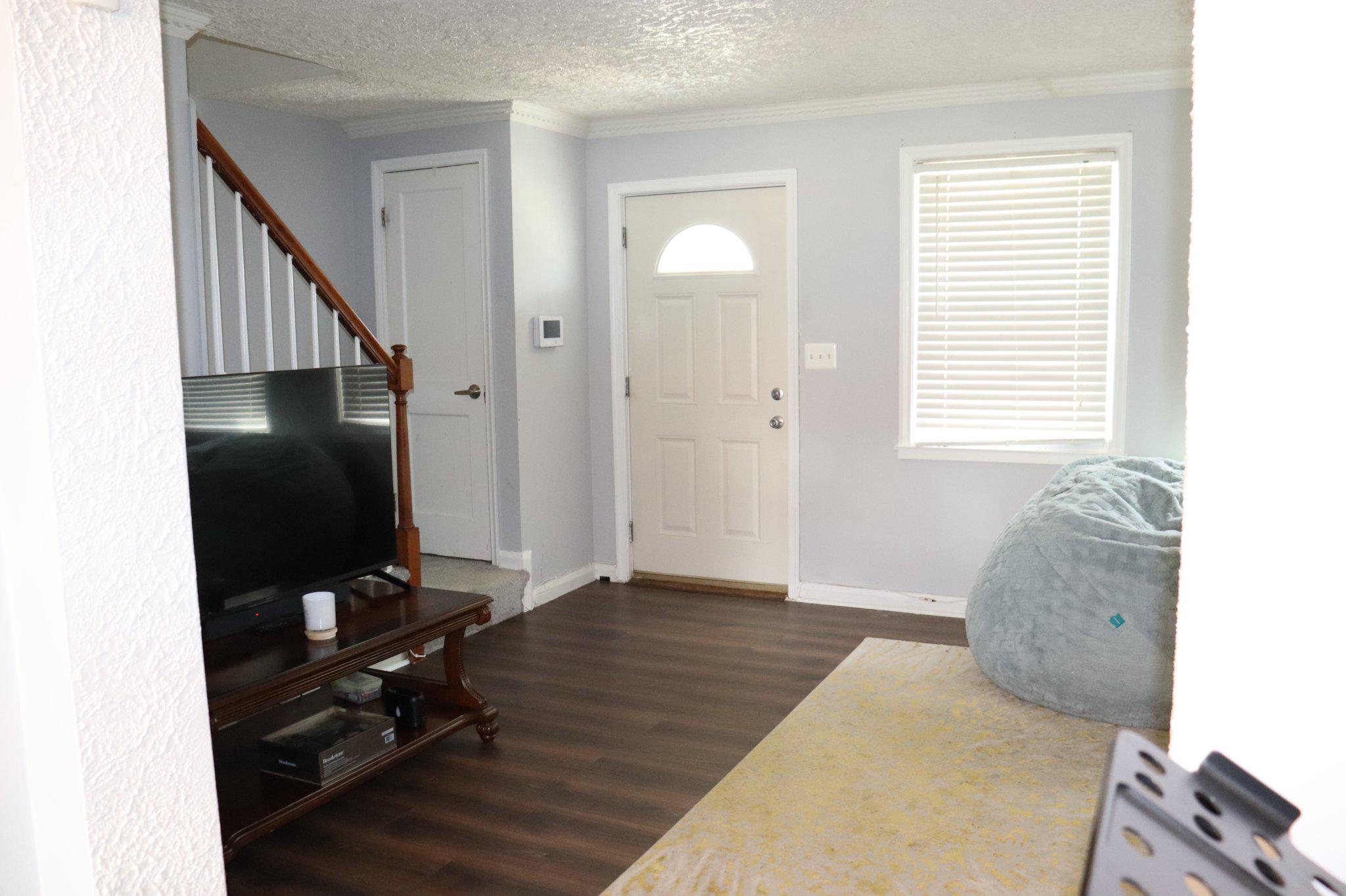 1328 Cedarcroft Road Baltimore, MD 21239 - Photo 6 of 39 Welcoming foyer with laminate floors and stair.