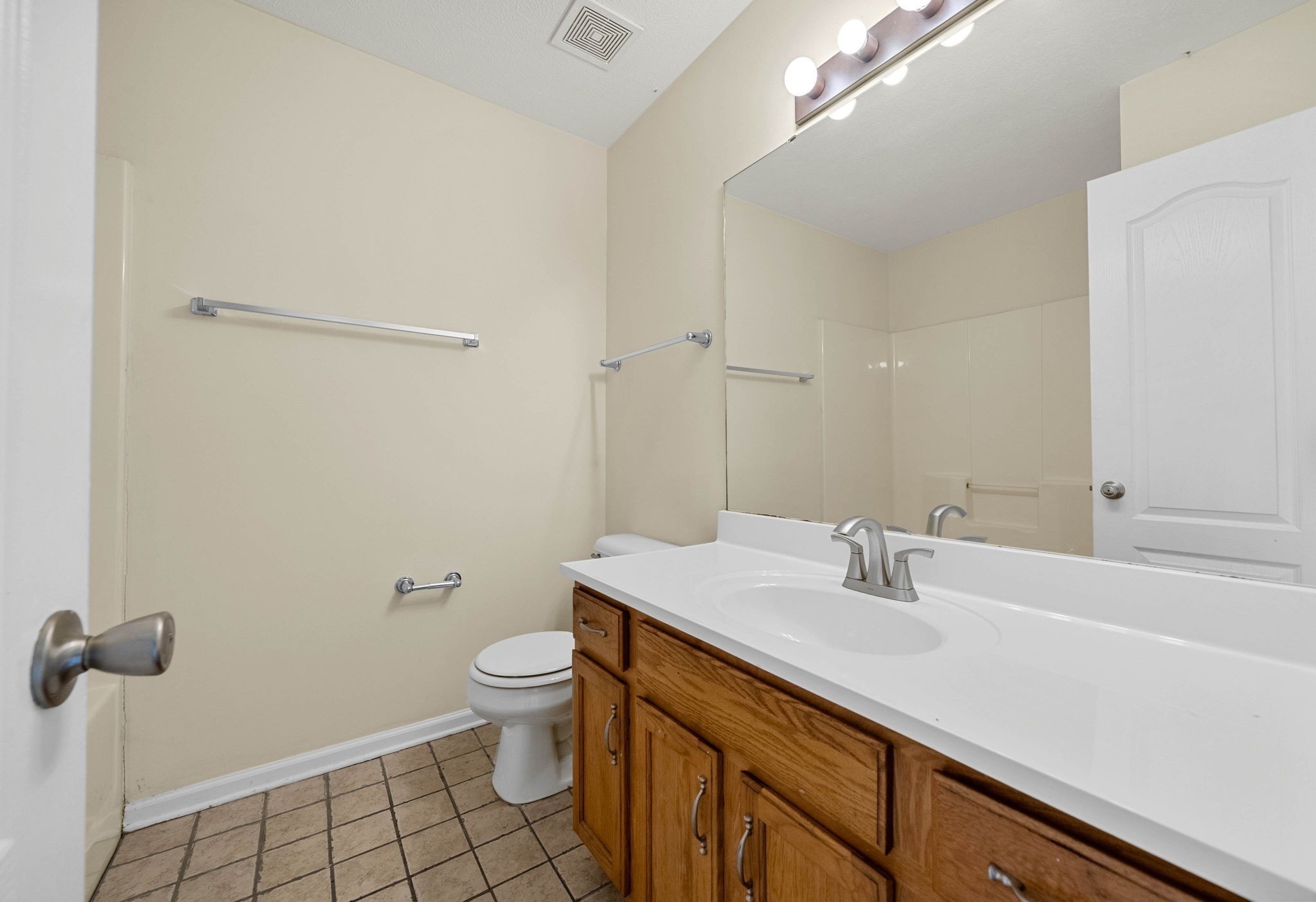 2331 Raleigh Court, Unit 7 Clarksville, TN 37043 - Photo 13 of 16 a bathroom with a sink a toilet a shower and a mirror