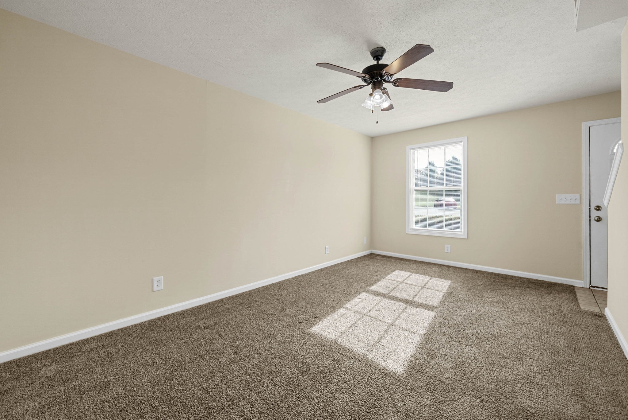 2331 Raleigh Court, Unit 7 Clarksville, TN 37043 - Photo 4 of 16 an empty room with windows and fan