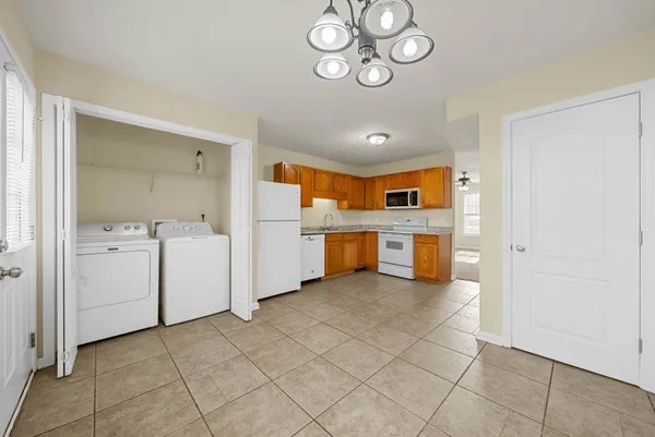 a view of storage and utility room with a hallway