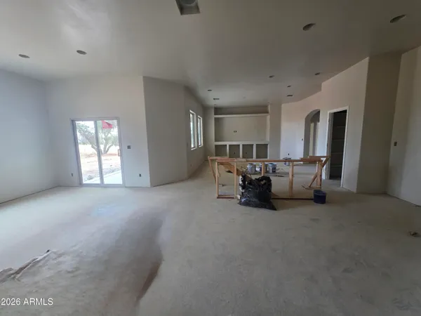 a view of house with a yard and sitting area