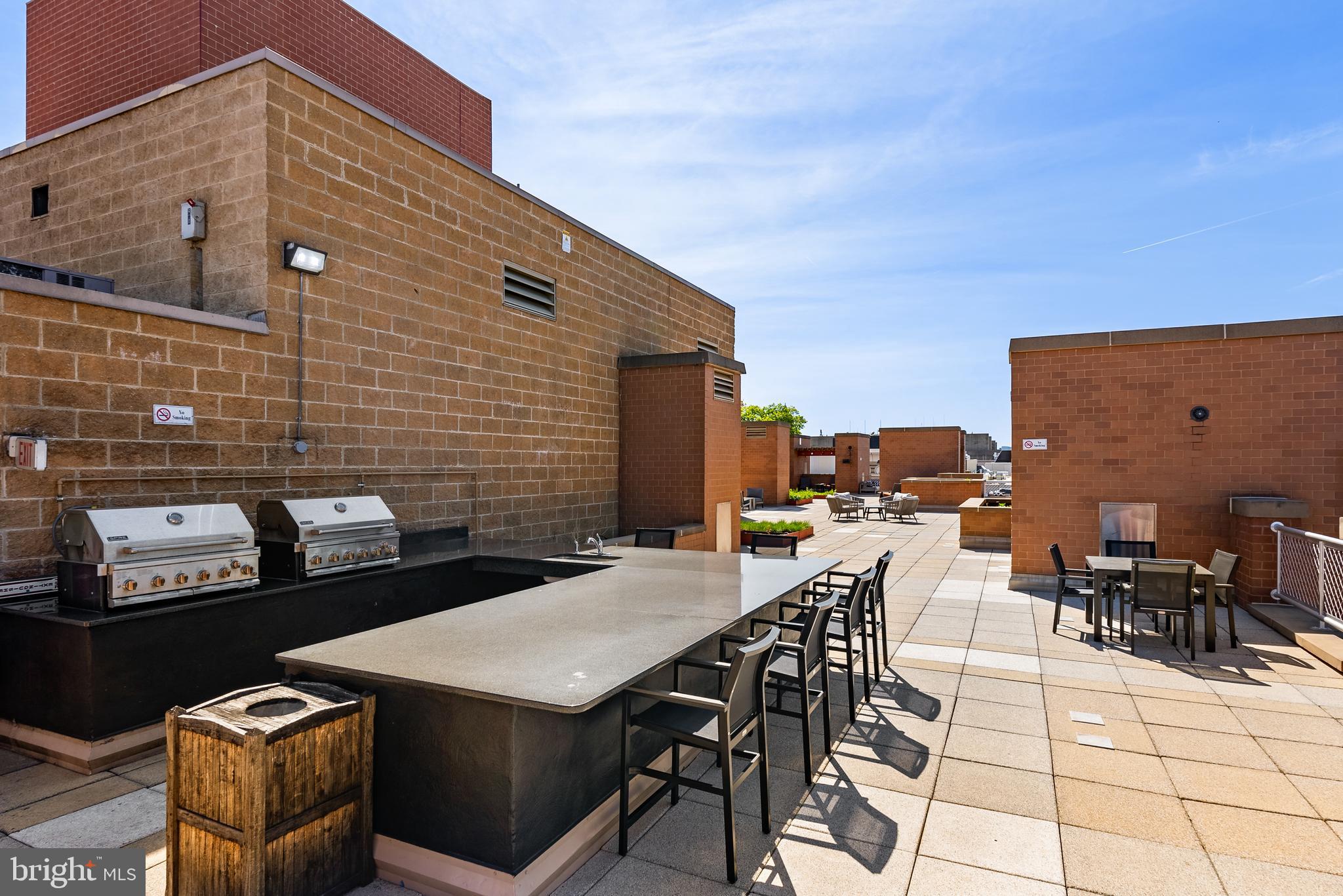 616 E Street Northwest, Unit 1019 Washington, DC 20004 - Photo 13 of 21 a roof deck with dining table and chairs