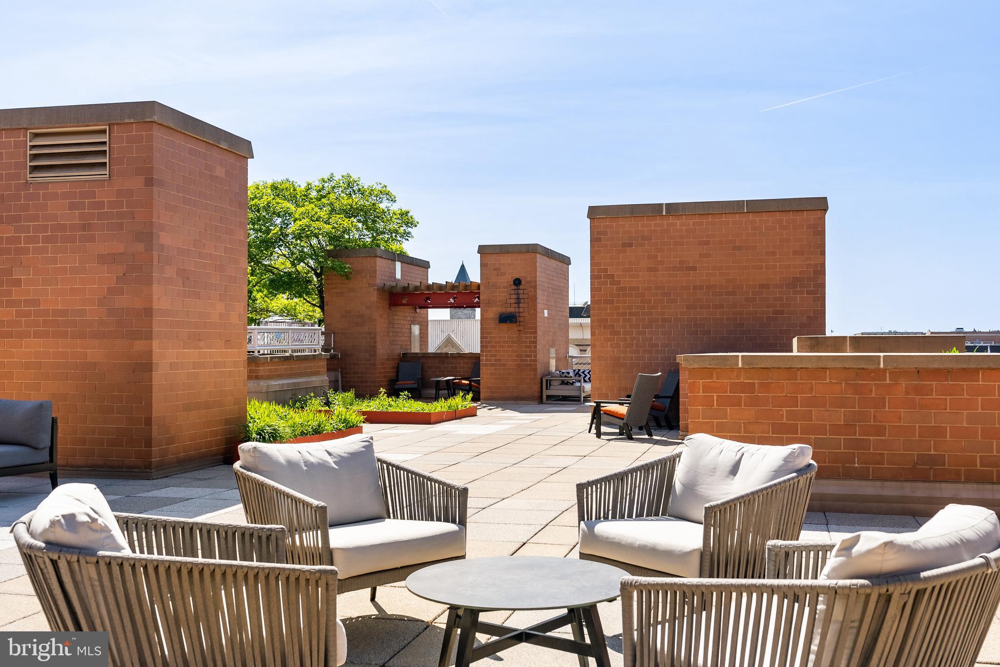 616 E Street Northwest, Unit 1019 Washington, DC 20004 - Photo 15 of 21 a balcony with furniture and a potted plant