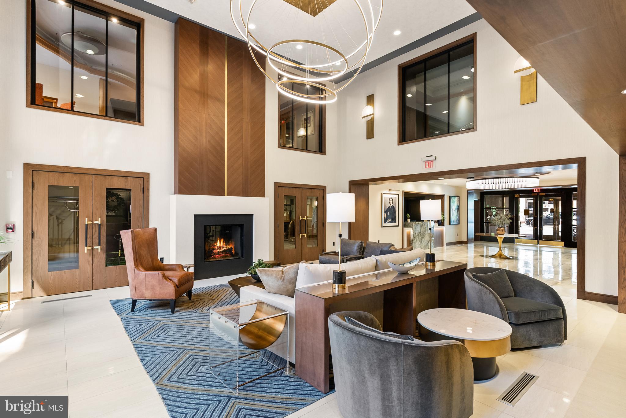616 E Street Northwest, Unit 1019 Washington, DC 20004 - Photo 17 of 21 a living room with furniture and a fireplace