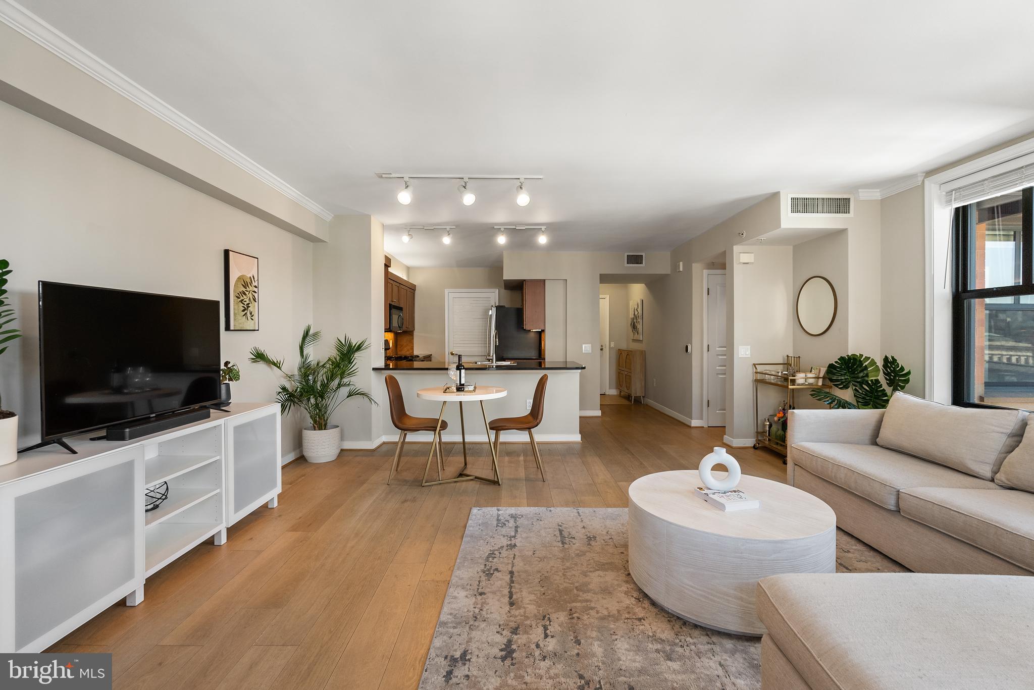 616 E Street Northwest, Unit 1019 Washington, DC 20004 - Photo 2 of 21 a living room with furniture and a flat screen tv
