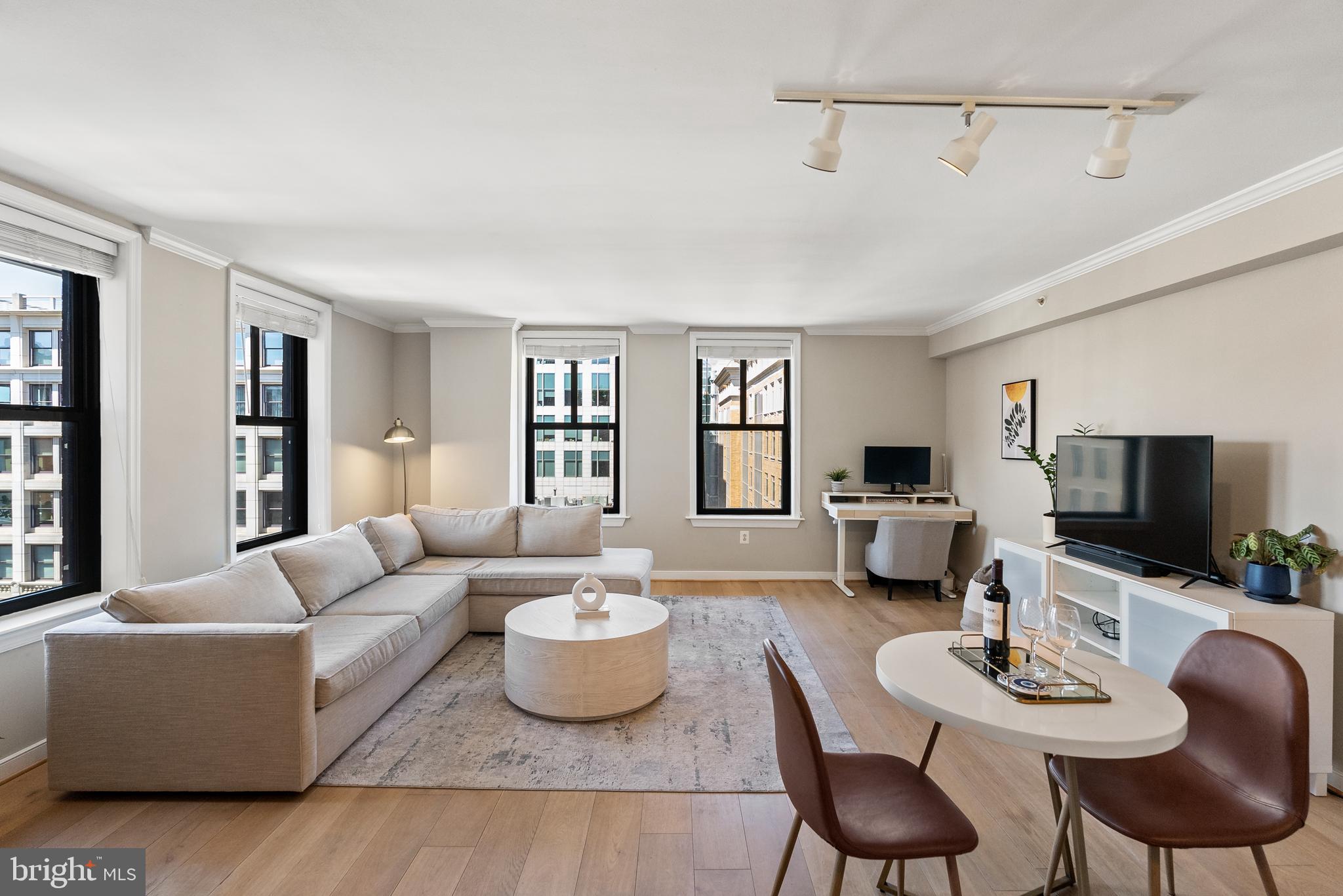 616 E Street Northwest, Unit 1019 Washington, DC 20004 - Photo 3 of 21 a living room with furniture and a flat screen tv
