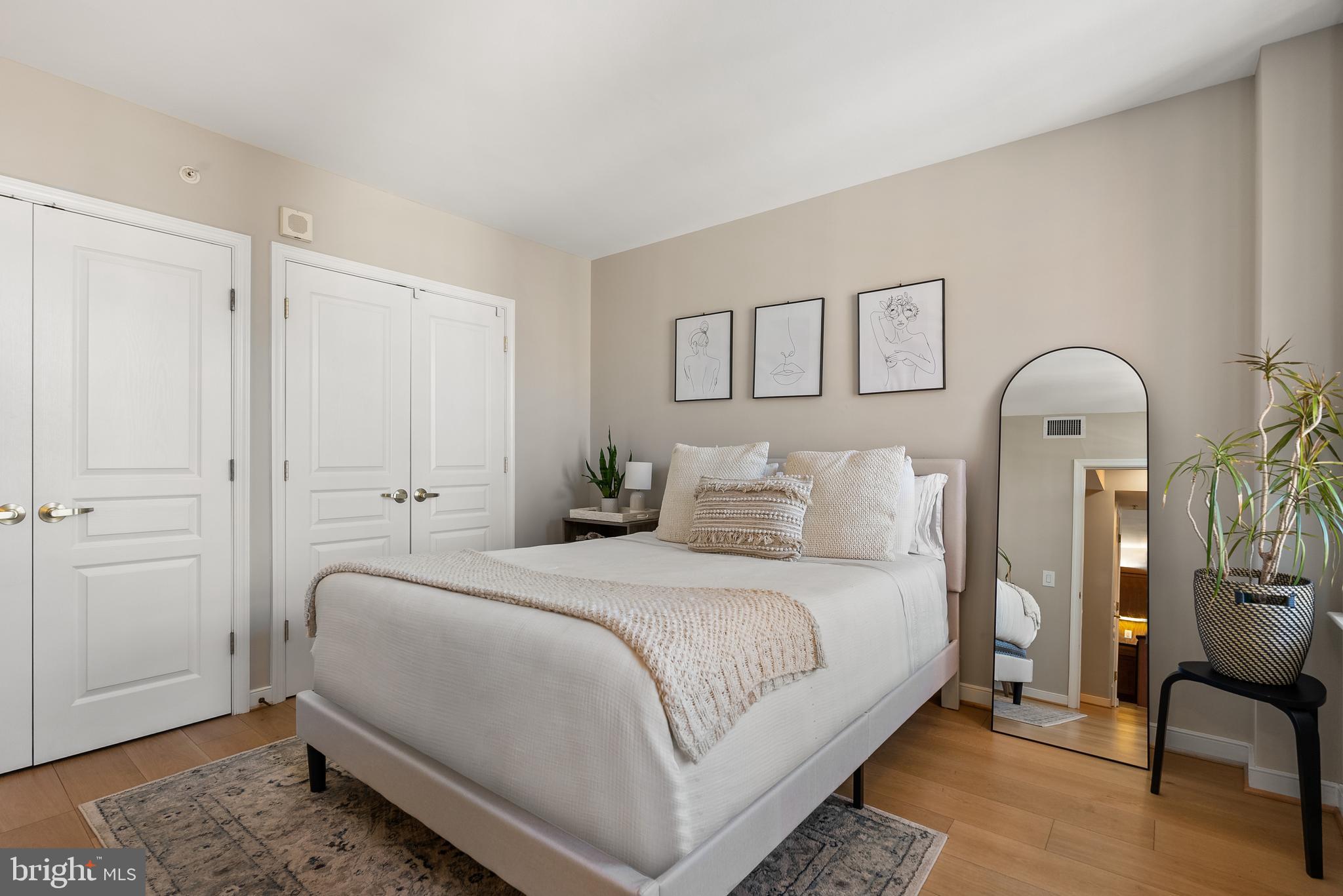 616 E Street Northwest, Unit 1019 Washington, DC 20004 - Photo 5 of 21 a bedroom with bed and a potted plant