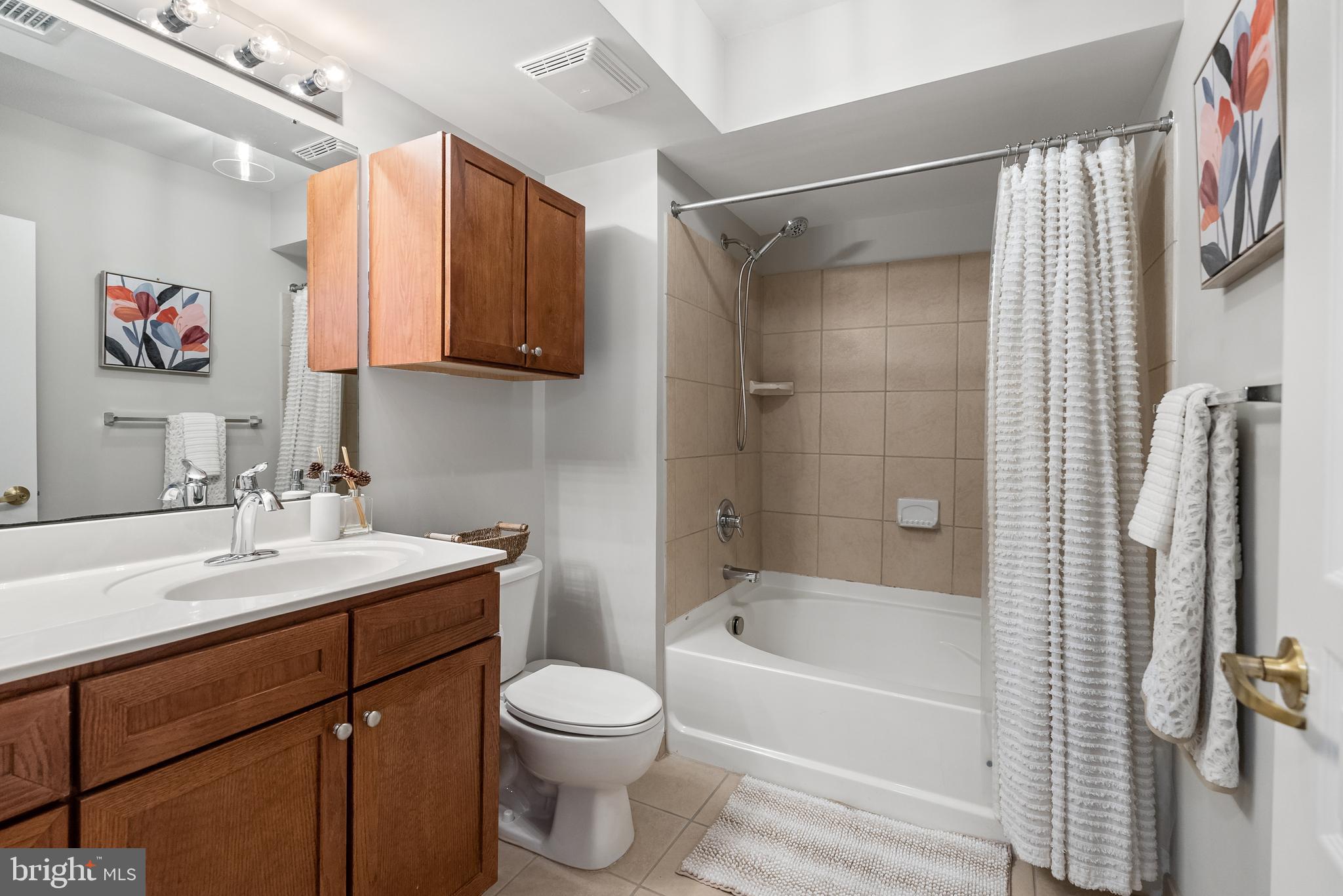 616 E Street Northwest, Unit 1019 Washington, DC 20004 - Photo 10 of 21 a bathroom with a sink toilet and shower