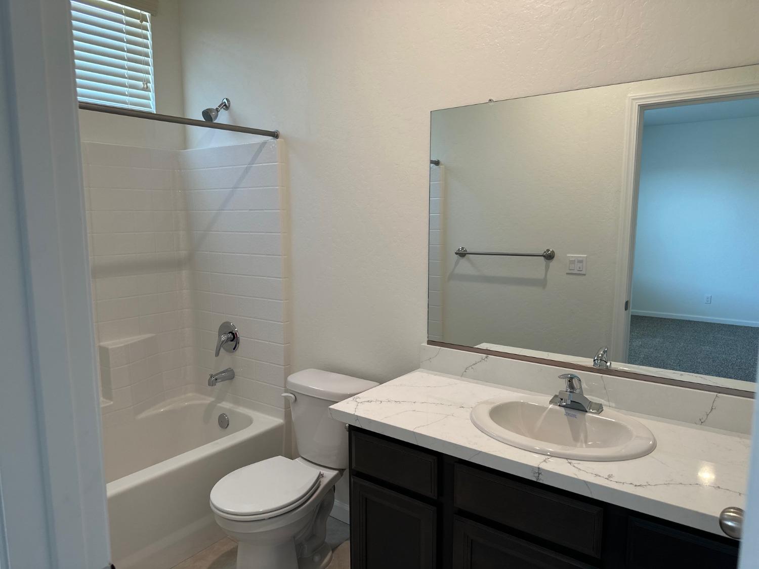 573 Green Lane Lemoore, CA 93245 - Photo 6 of 7 a bathroom with a sink and a mirror
