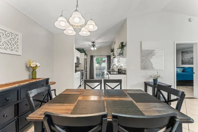 a view of a dining room with furniture and chandelier