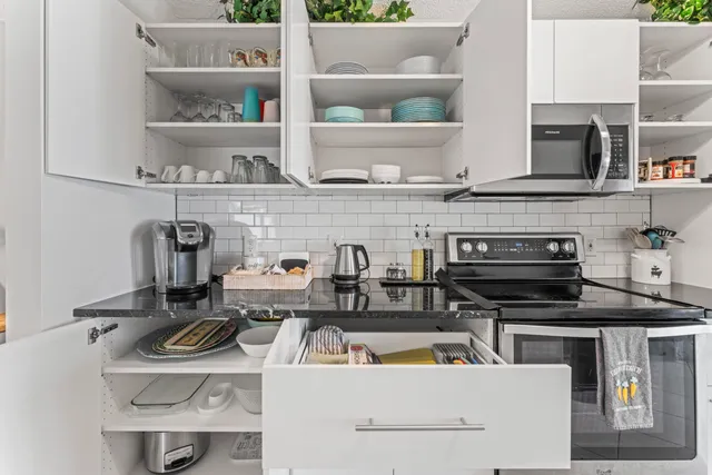 a view of kitchen with appliances and cabinets