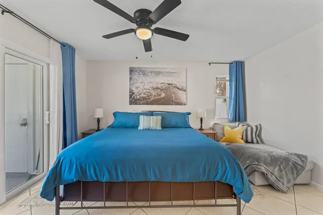 a bedroom with a bed and a painting on the wall