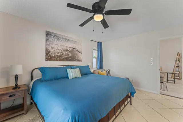 a bed room with a bed and a chandelier