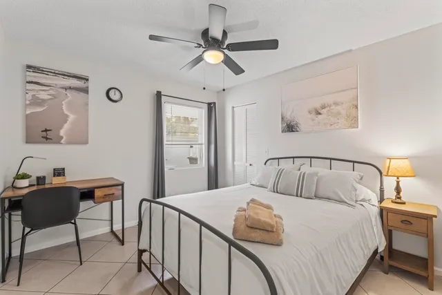 a view of a bedroom with wooden floor