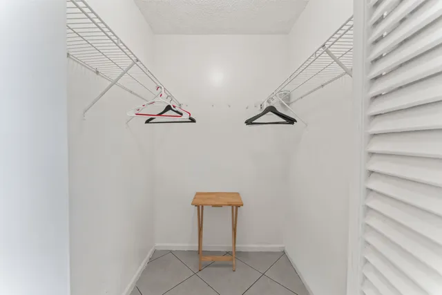 a bedroom with two beds and a window