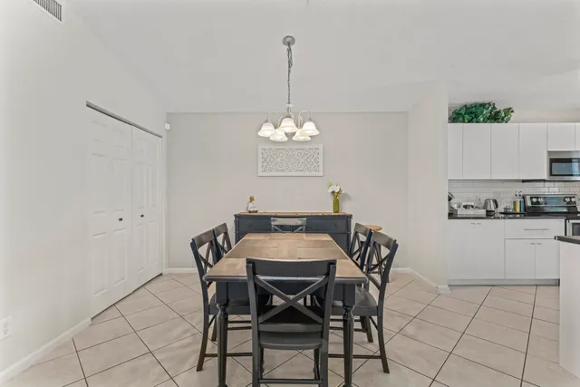 a view of a dining room with furniture and chandelier