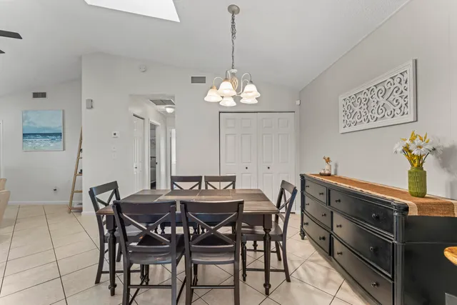 a view of a dining room with furniture and chandelier