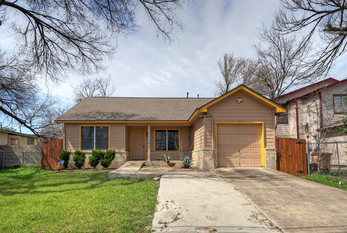 a front view of a house with yard and green space