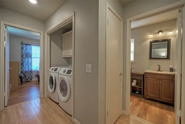a view of a storage and utility room with washer and dryer