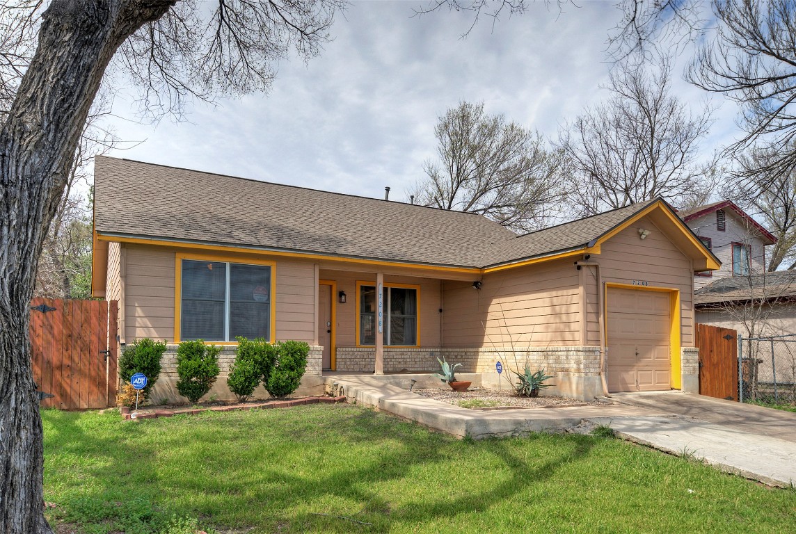 7208 Bennett Avenue Austin, TX 78752 - Photo 2 of 30 a front view of a house with yard and green space