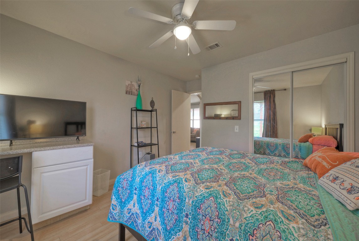 7208 Bennett Avenue Austin, TX 78752 - Photo 22 of 30 a bedroom with a bed and a flat screen tv