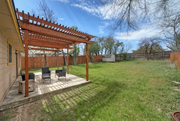 a view of a patio with a table and chairs under an umbrella