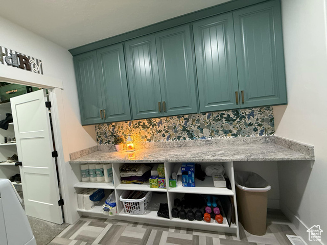 1240 West 2360 North Helper, UT 84526 - Photo 46 of 79 Interior space with green cabinetry, open shelves, and tasteful backsplash