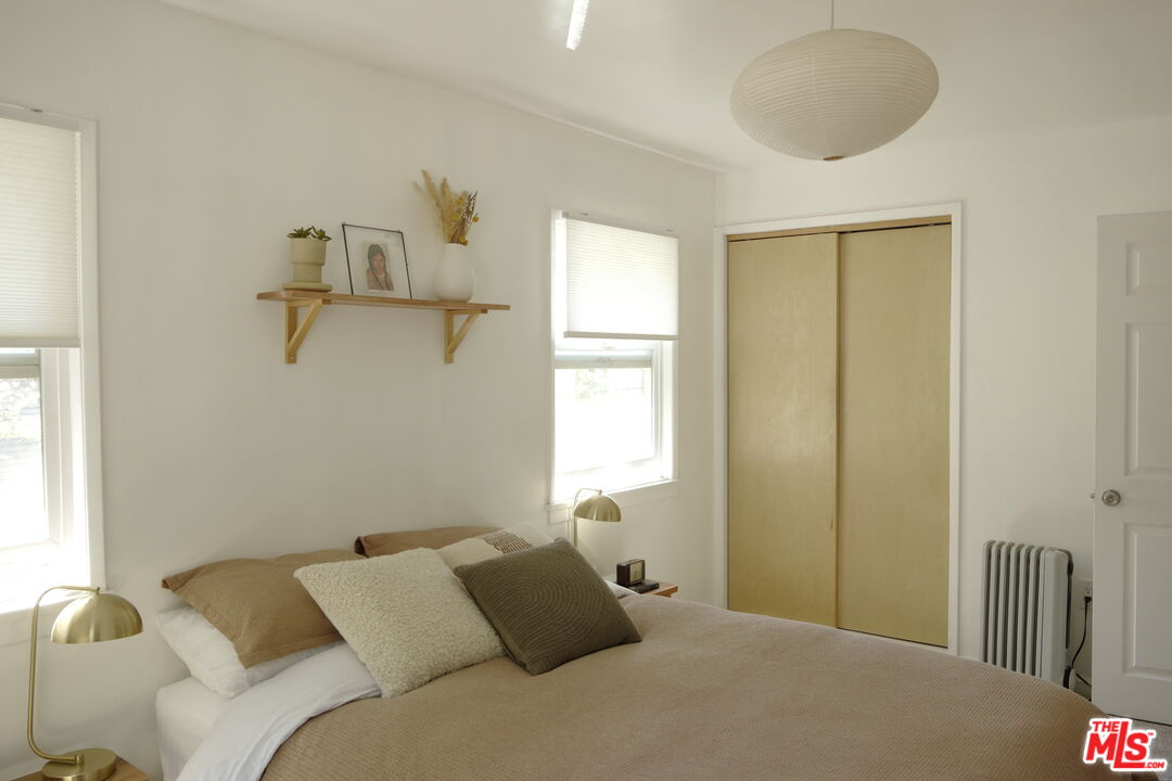 53505 Tollgate Road Idyllwild, CA 92549 - Photo 15 of 42 a bedroom with a bed and a chandelier
