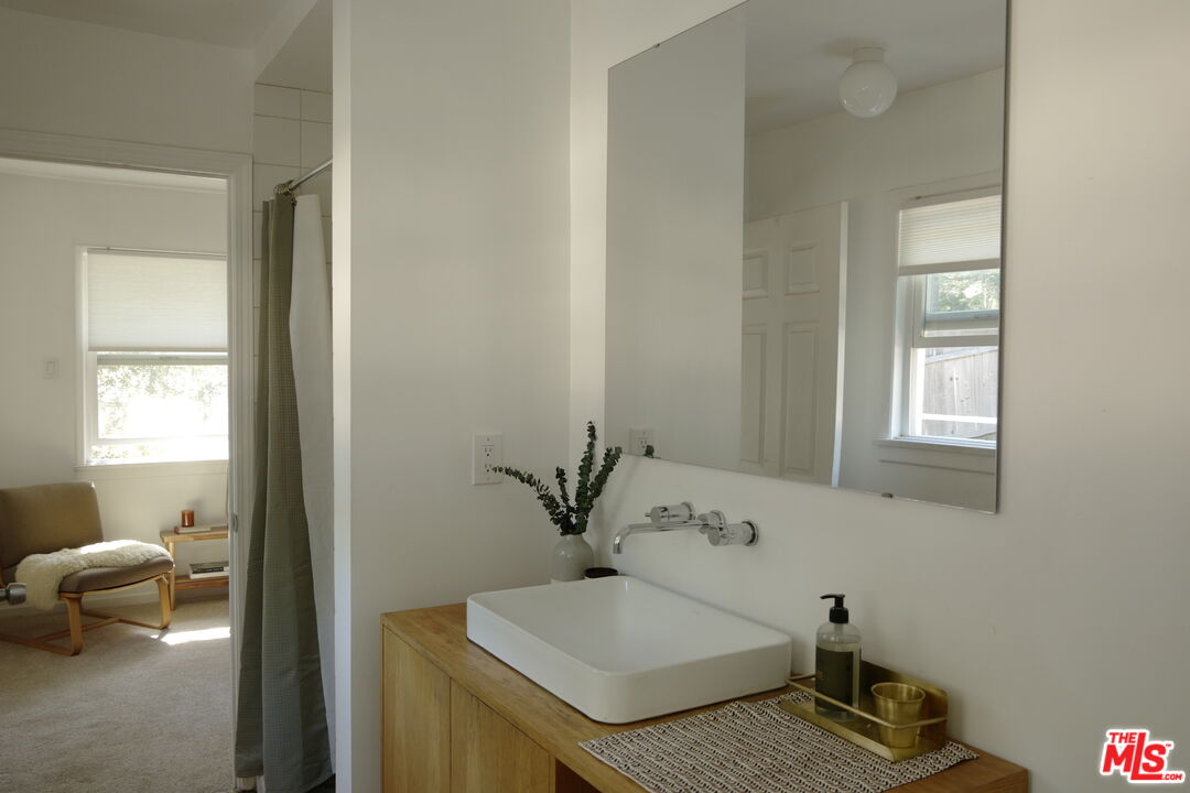 53505 Tollgate Road Idyllwild, CA 92549 - Photo 17 of 42 a bathroom with a granite countertop sink and a mirror