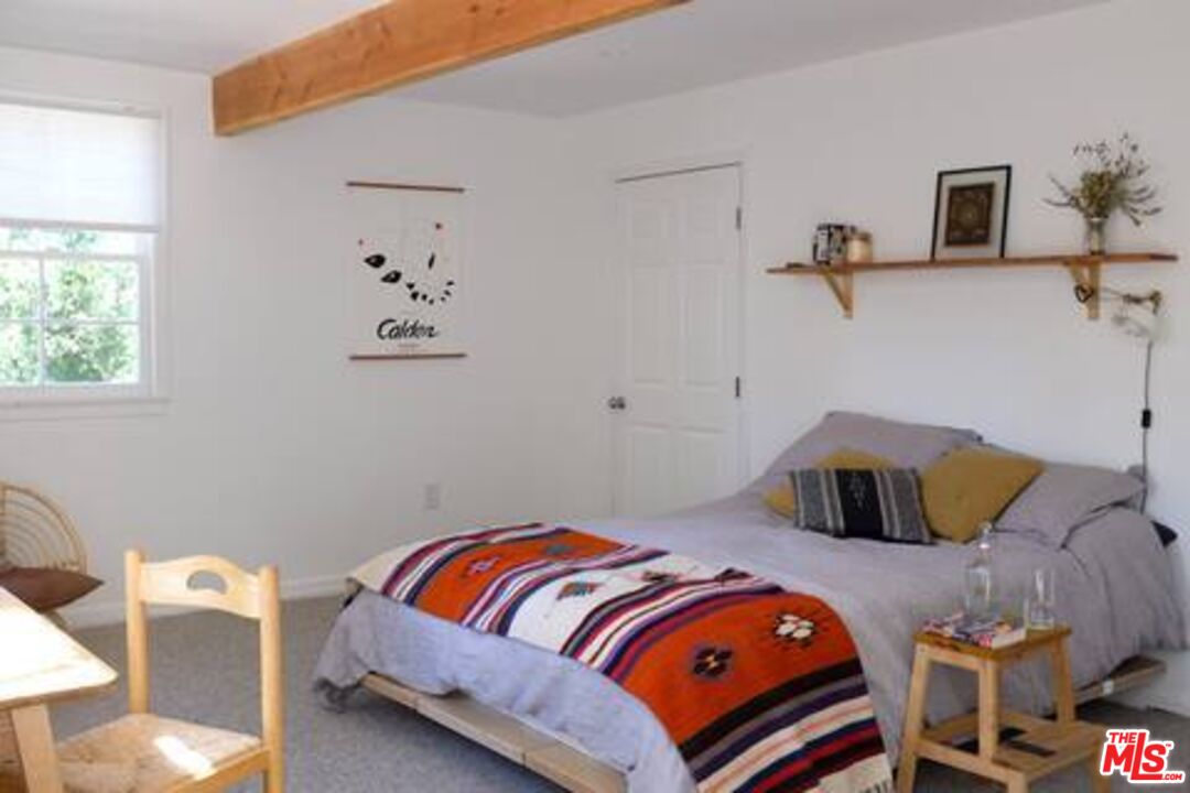 53505 Tollgate Road Idyllwild, CA 92549 - Photo 25 of 42 a bedroom with a bed and window