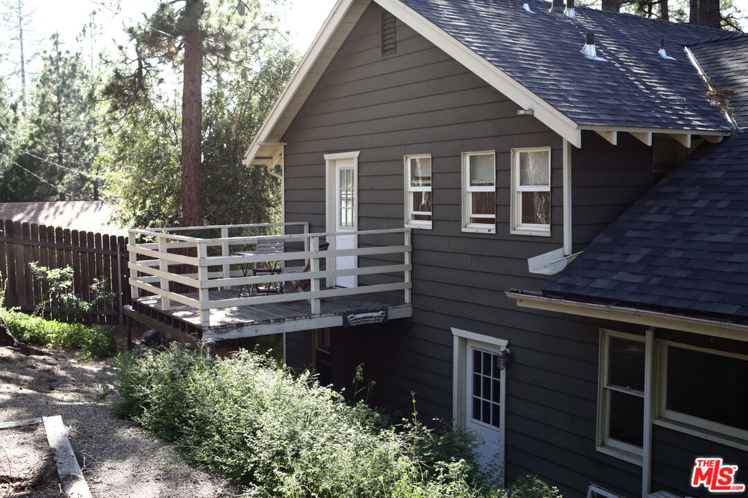 53505 Tollgate Road Idyllwild, CA 92549 - Photo 36 of 42 a view of a house with a large window and wooden fence