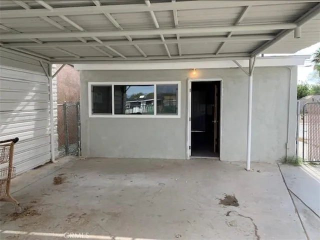 a view of a big room with wooden floor and windows