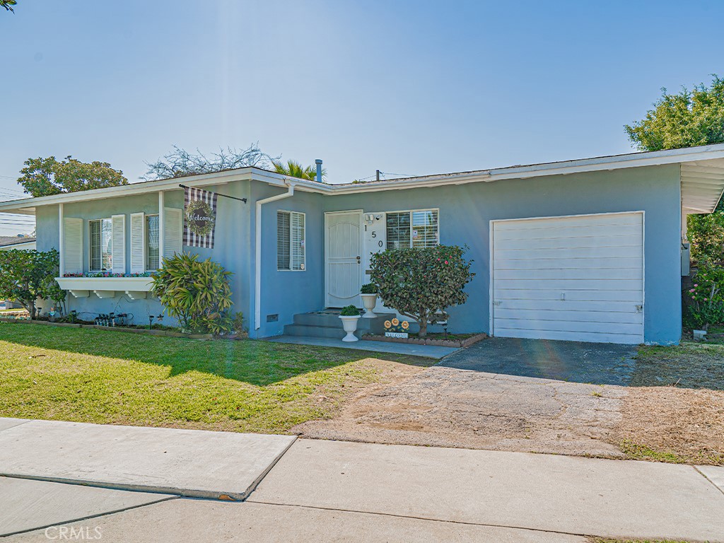 a front view of house with yard and green space
