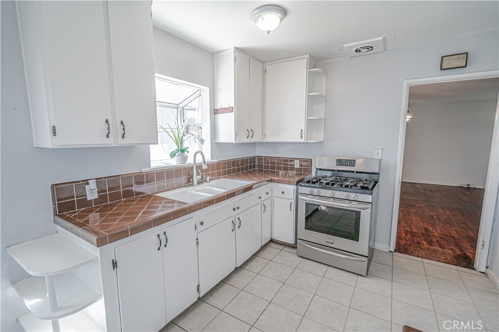 150 East 233rd Street Carson, CA 90745 - Photo 11 of 22 a kitchen that has a sink and a stove