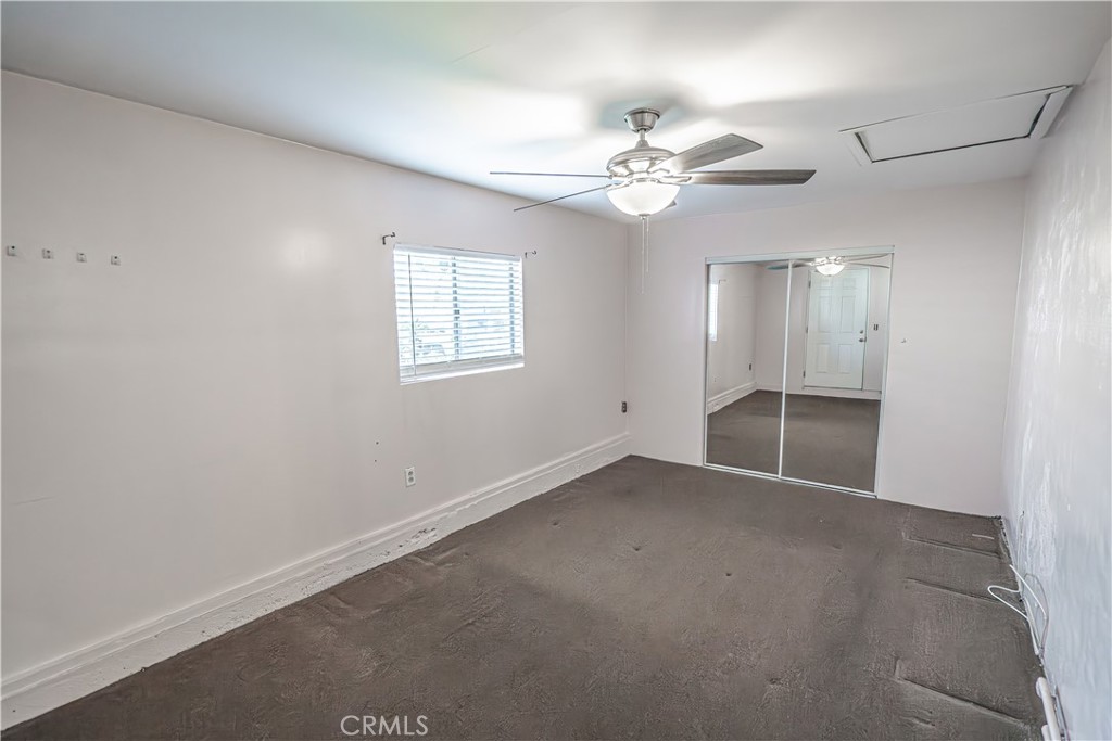 150 East 233rd Street Carson, CA 90745 - Photo 16 of 22 an empty room with chandelier fan and windows