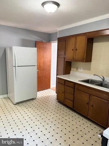 a kitchen with a refrigerator and a sink