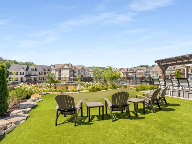 a view of swimming pool with outdoor seating and city view