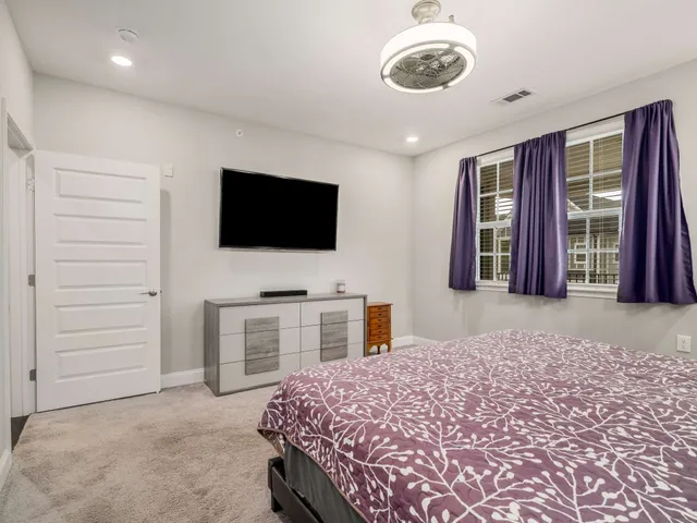 a bedroom with a bed and a flat screen tv