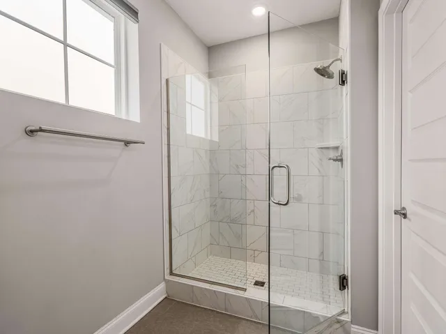 a bathroom with a glass shower door