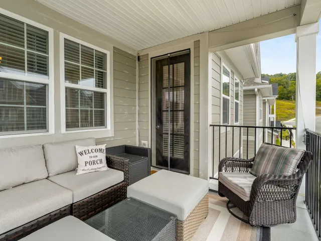 a balcony with furniture and front door