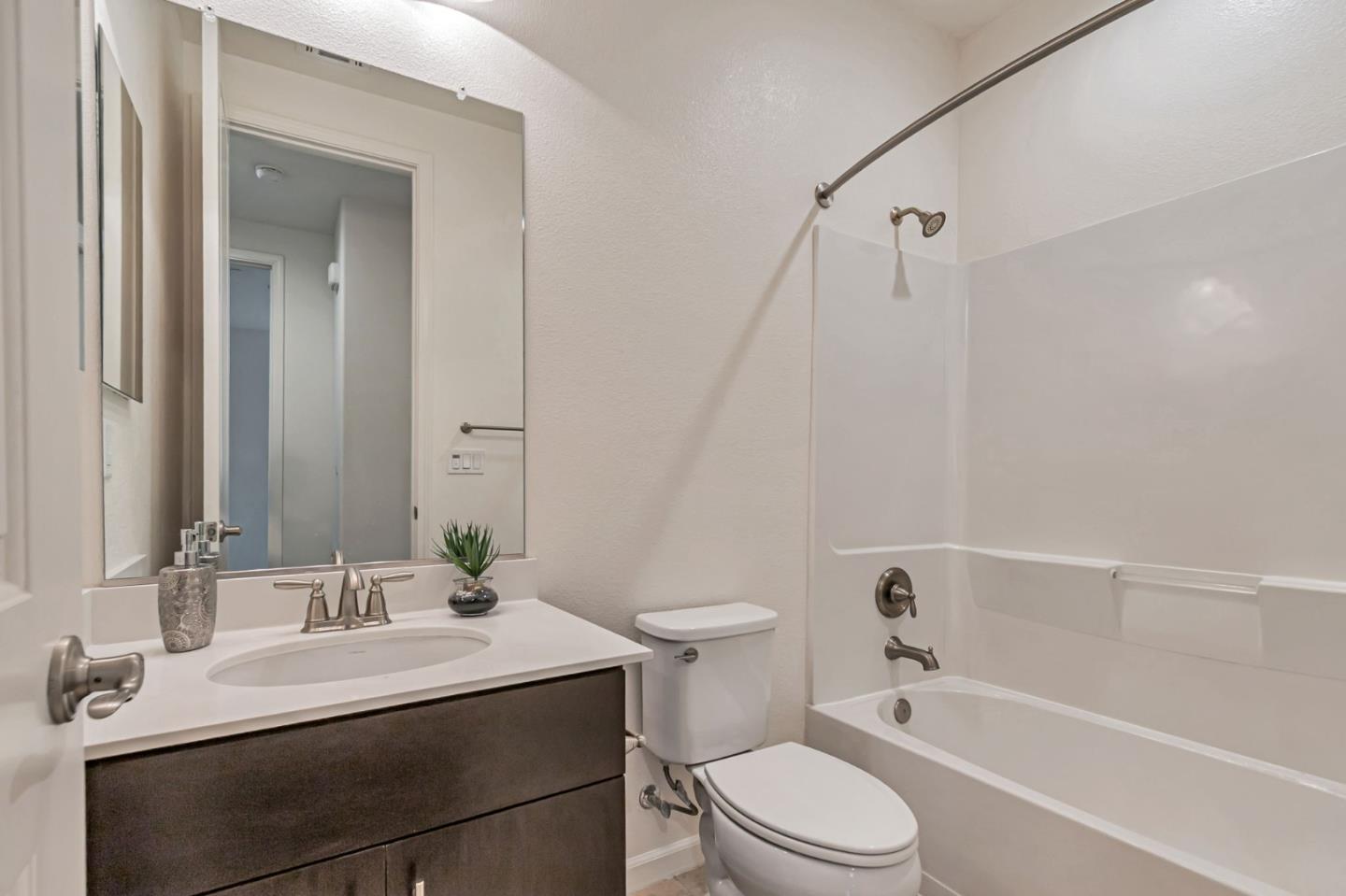 1890 Trento Loop Milpitas, CA 95035 - Photo 13 of 39 a bathroom with a sink toilet vanity and shower
