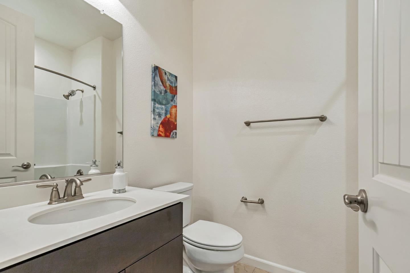 1890 Trento Loop Milpitas, CA 95035 - Photo 14 of 39 a bathroom with a sink toilet and a mirror