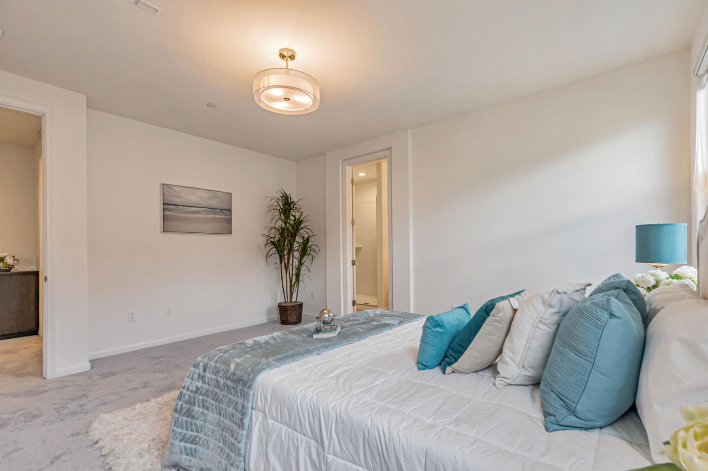 1890 Trento Loop Milpitas, CA 95035 - Photo 20 of 39 a bedroom with a bed and a potted plant